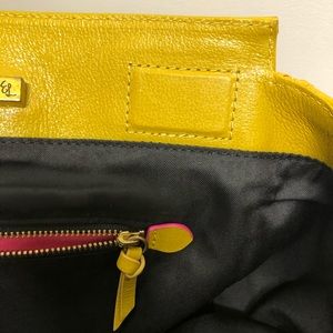 An Elliott Lucca gently used mustard color bag